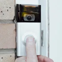 Close up a thumb press button of a Ring Doorbell
