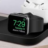 The black watch is on charge, wireless charging of the wristwatch gadget