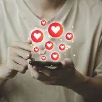 Chat and notification on smartphone with virtual red heart emoji social media icon