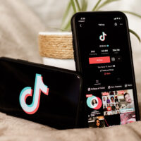 Close up of two phones showing the TikTok app