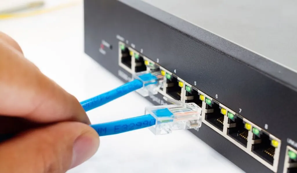 LAN network switch with ethernet cables plugging in