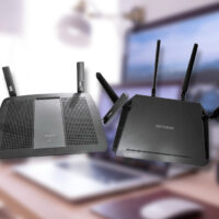 Linksys AC2400 and Netgear Nighthawk X4 AC2350 side by side over a blurred office