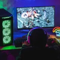 Young gamer playing at strategy online game