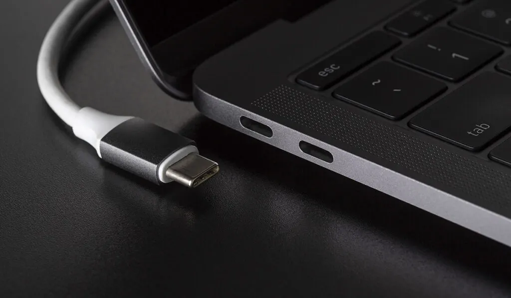 Close up of USB-C ports of a laptop with USB-C cable 