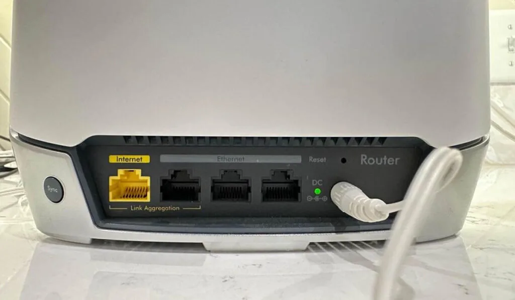 Close up of an Orbi router's control panel and ports
