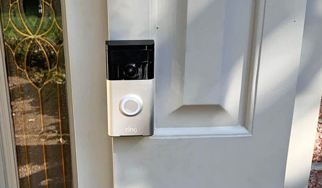 Ring doorbell installed onto a white door
