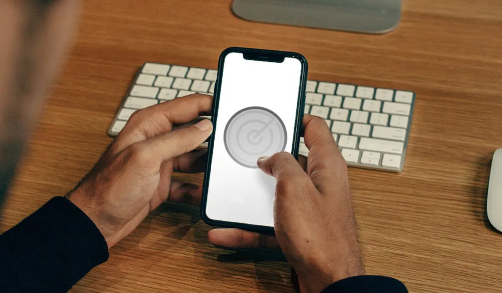 man holding iphone with greyed out radar icon