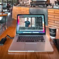 A Macbook Pro with a Final Cut Pro open in a coffee shop