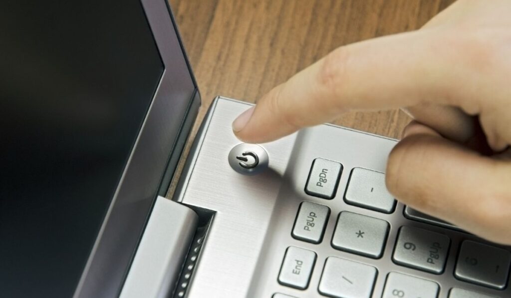 Power button on metallic silver laptop keyboard