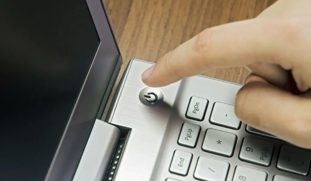 Power button on metallic silver laptop keyboard