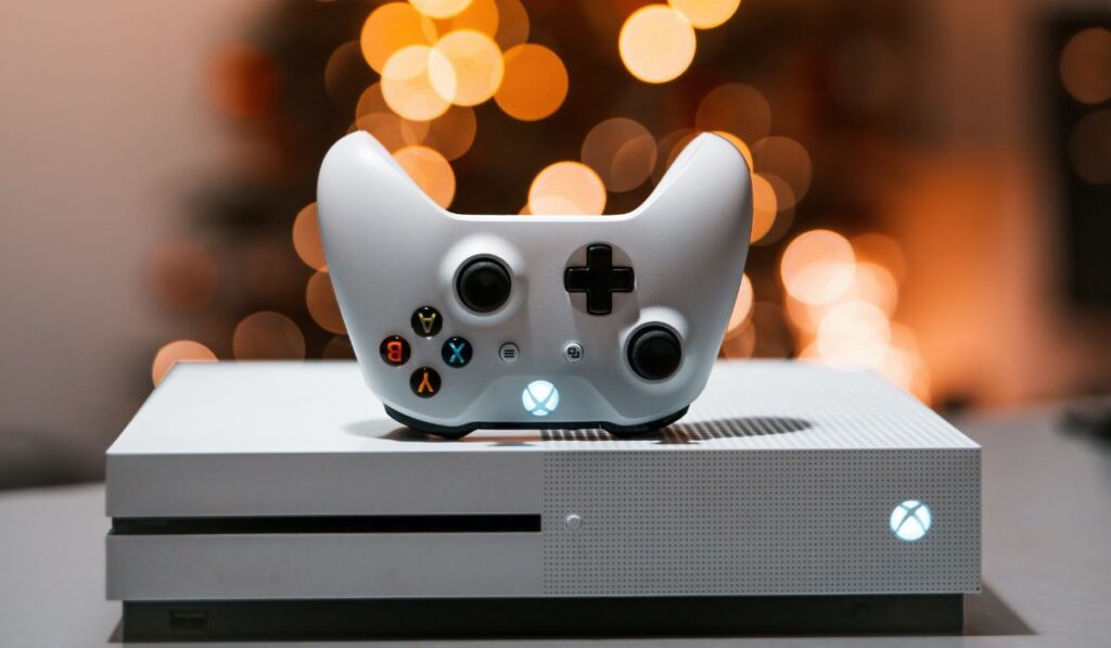 White Xbox one S console with a controller