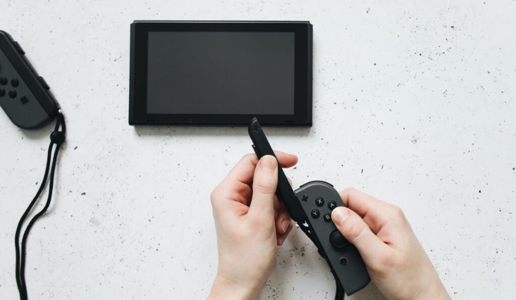 Hands Holding the Controller of Nintendo Switch